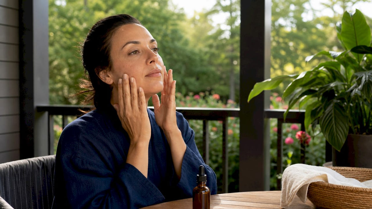 Woman applying skin repair serum at home vanity
