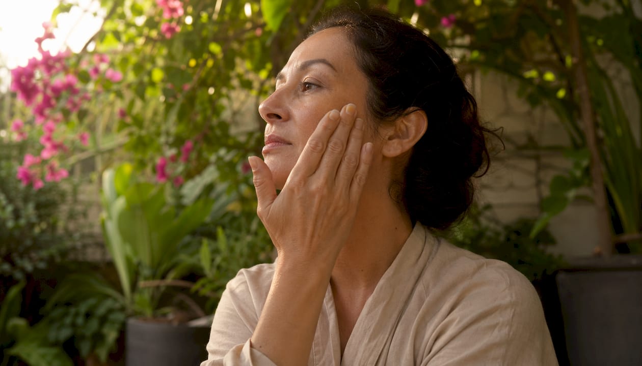 Woman applying retinaldehyde serum