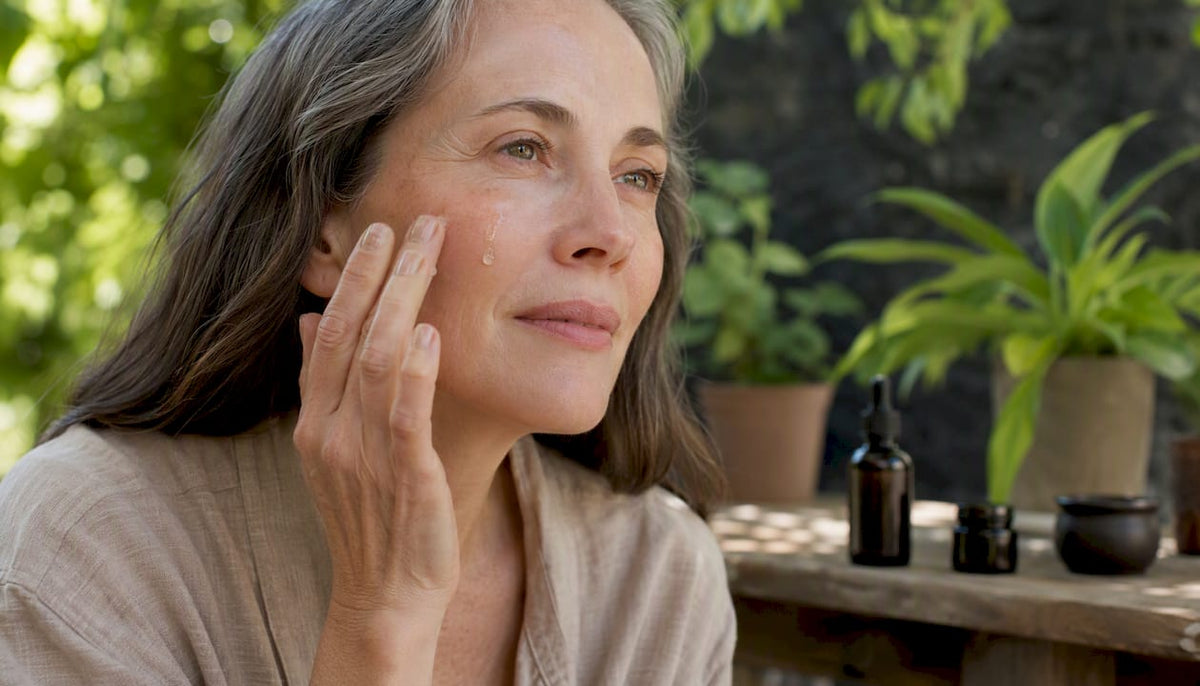 Hand applying anti-aging serum on face