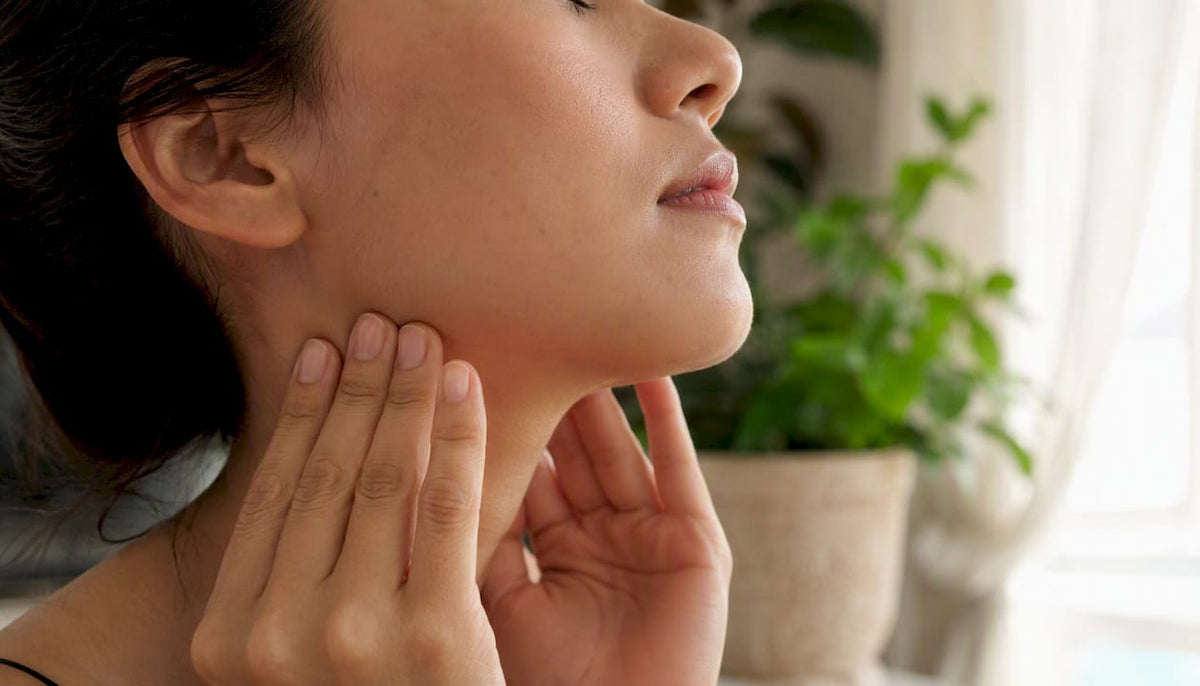 Hands gently touching midface skin