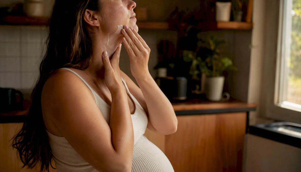 Pregnant woman applying SPF 50+ sunscreen