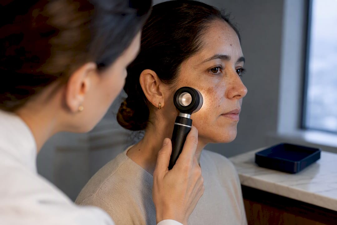 Dermatologist examining symmetrical facial pigmentation