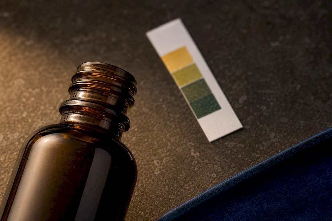 Anonymous serum bottle beside pH strip